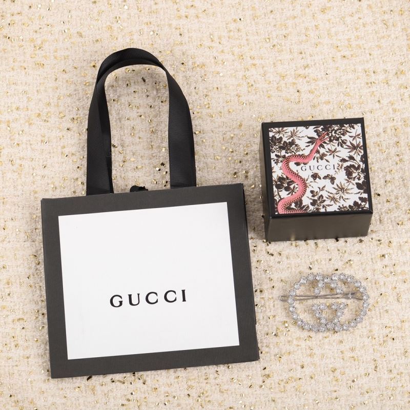 G*u*i brooches
